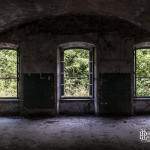 Intérieur d'une pièce de la caserne avec trois fenêtres au Fort du Haut Buc