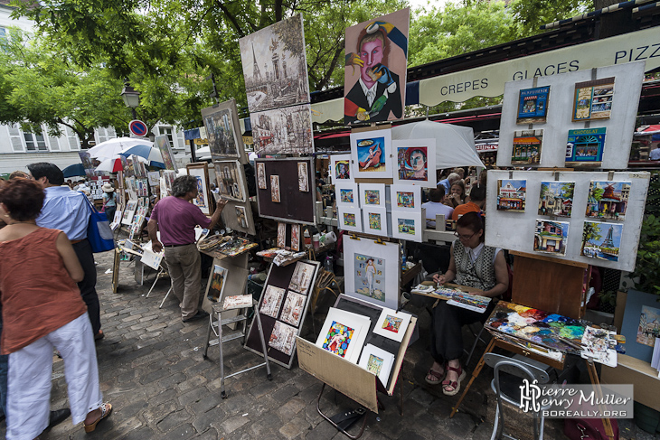 Peintres réalisant une toile de peinture sur la place du Tertre à Paris