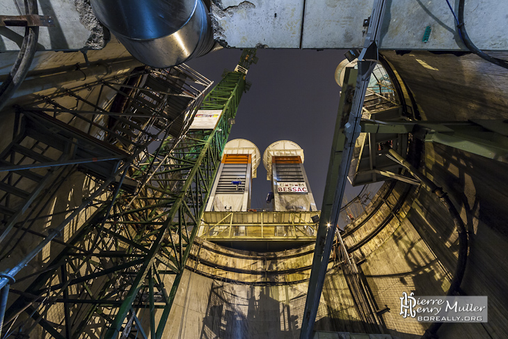 Vue depuis le fond du puits sur la grue et les réservoires à remblais